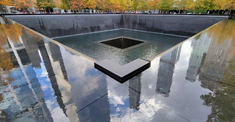 NYC: 9/11 Memorial and Financial District Walking Tour - Reading the 9/11 Memorial pools with a guide