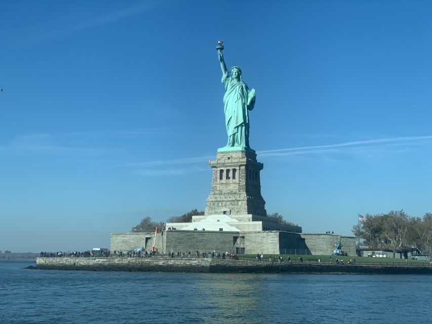 NYC: 9/11 Memorial, Wall Street, and Statue of Liberty Tour - Walking through Wall Street’s Financial District