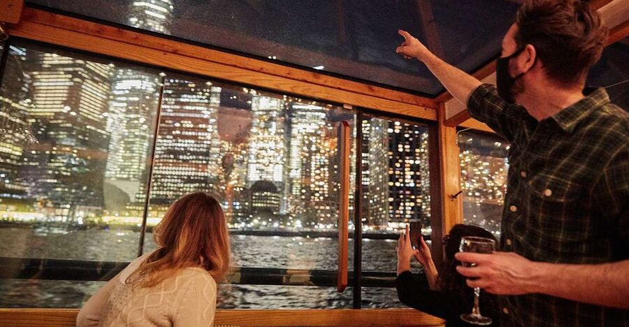 NYC: City Lights Yacht Cruise with Drink Included - The Statue of Liberty and Ellis Island after dark