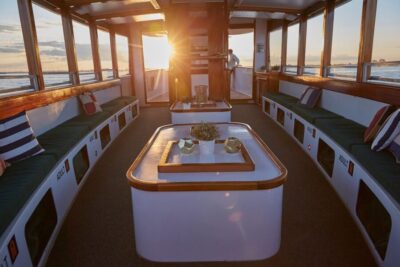 Sunset Cruise on a Small Yacht with a Drink
